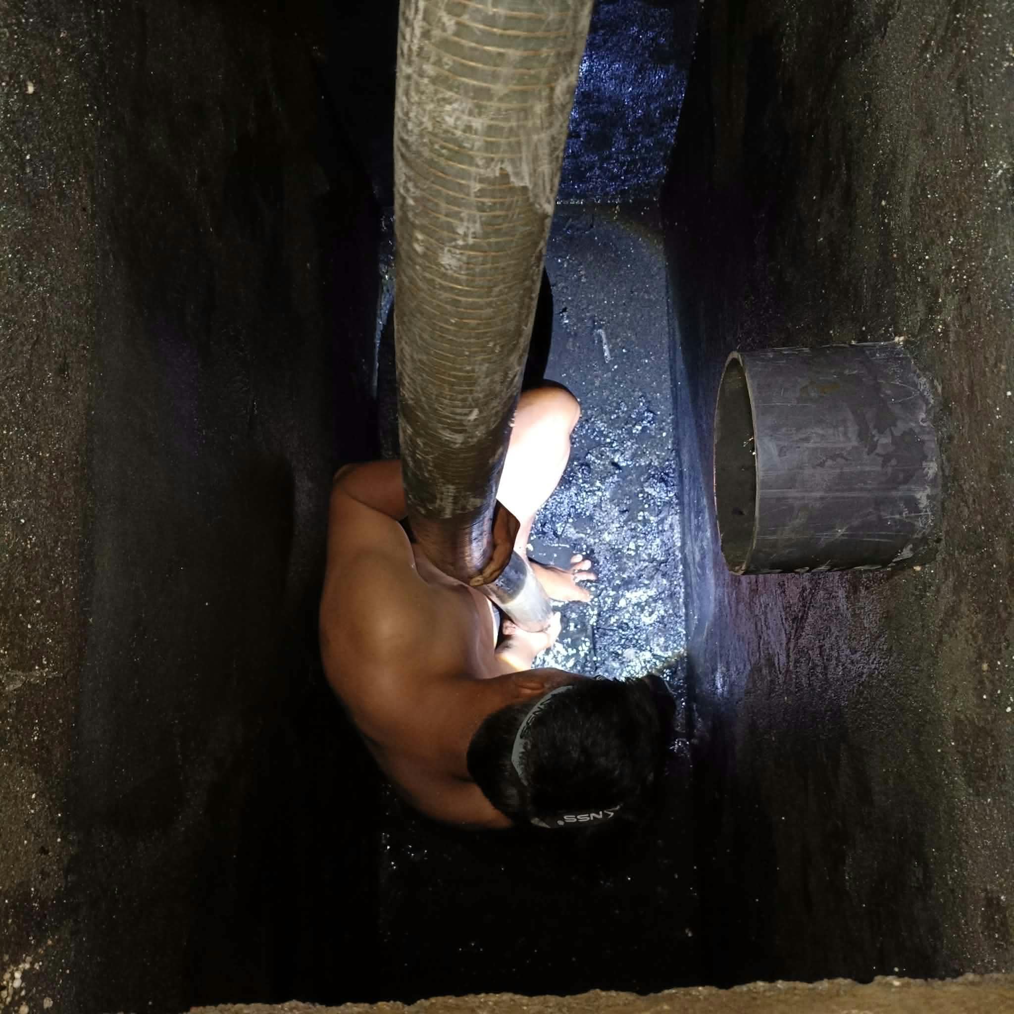 Crew member working on a septic tank cleaning job