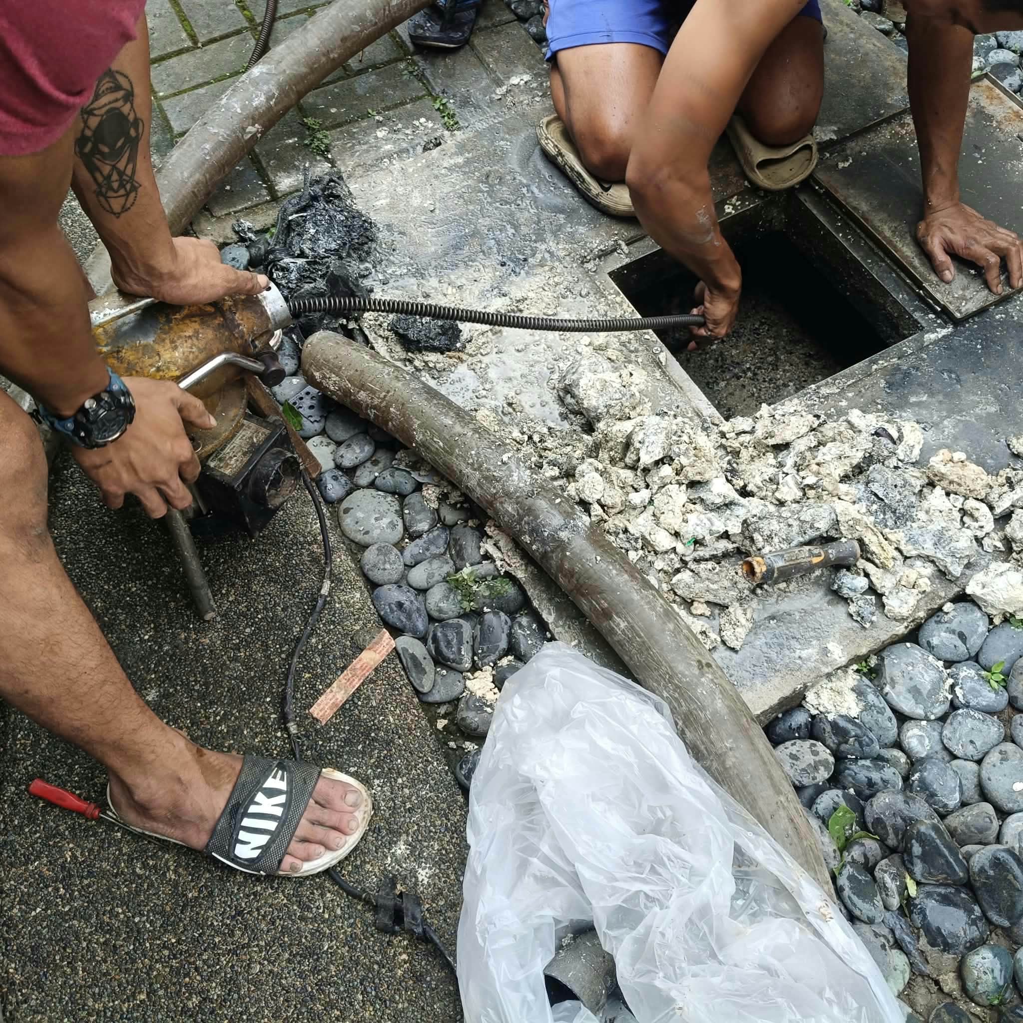 Crew member working with drain-cleaning equipment